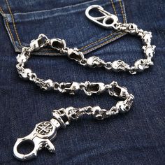 Phantom Skull 925 Sterling Silver Biker Wallet Chain New   Constructed from premium 925 sterling silver;  The clasp carries 925 hallmark;   Weight: approximately 216 grams;   Length: 23” (58 cm);  Link width: 0.6” (15 mm);  Hand-made piece.   It doesn’t get more badass than a display of ferocious skulls. With Phantom Skull 925 Sterling Silver Biker Wallet Chain brought to you by Bikerringshop, you’ll be able to take your biker style up a notch. This piece is equally epic, well-made, and audaciou Skull Wallet, Wallet Chains, Small Skull, Biker Wallet, Biker Jewelry, Belt Accessories, Biker Style, Wallet Chain, Cleaning Jewelry