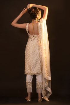 White sleeveless kurta with checkered brocade woven motifs and pearl embellished drops on hem. Paired with straight pant and border woven sheer dupatta. - Aza Fashions Fitted Traditional Wear With Woven Motifs For Eid, Fitted Sleeveless Chanderi Kurta, Elegant Sleeveless Traditional Wear For Diwali, Elegant Sleeveless Traditional Wear With Dupatta, Elegant Sleeveless Designer Traditional Wear, Elegant Festive Sets With Woven Motifs, Elegant Chanderi Traditional Wear With Woven Motifs, Unstitched Elegant Sleeveless Kurta, Elegant Sleeveless Kurta With Chikankari Embroidery