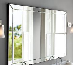 a bathroom sink with a large mirror above it