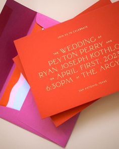 the wedding stationery is made up of different colors and sizes, including pink, purple, orange, and red