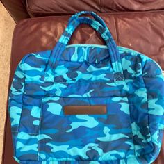 a blue and black bag sitting on top of a couch