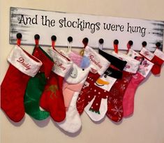 stockings are hung on the wall with a sign above them that says and the stockings were hung