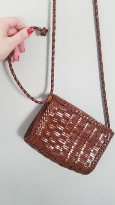 A sweet staple for spring, this woven leather vintage cross body bag is perfect for casual happenings. A braided leather strap and all the room you need for essentials make it a just right grab and go bag. The strap slides through a loop, so you can also tie it off for a shorter look._DETAILS_ Woven & Braided Leather Cross Body L. J. S. Collection One Main Compartment No pocketsApprox. Measurements: 7. 5 inches wide x 6 inches tall 2 3/4 inches thick Strap is approx. 50 inches total / 24 inch hangSome surface wear, consistent with age and use. Noted: Finish on zipper button is flakes, noted fleck of white paint on strap near shoulder height. Some spots of discoloration Brown Braided Crossbody Bag, Spring Braided Brown Shoulder Bag, Brown Woven Leather Shoulder Bag For Spring, Spring Brown Woven Leather Shoulder Bag, Brown Braided Rectangular Shoulder Bag, Vintage Woven Shoulder Bag For Everyday Use, Vintage Brown Woven Leather Shoulder Bag, Vintage Brown Shoulder Bag For Spring, Scarab Bracelet