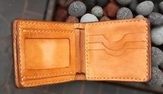 "Tooled billfold roper cowboy biker wallet hand carved Sheridan western style. The outer is made from 8-9 oz. vegetable tanned leather*. It is dyed, covered with a special compound** to protect against moisture, and finished with a clear gloss giving it a lasting shine. 9 1/2\" x 4\" You can customize dimensions before ordering The interior has 3 credit card compartments, 1 ID, 2 billfold compartments, 1 full length bill compartment. Tooled billfold wallet hand carved leather Sheridan style is h Custom Hand Tooled Leather Trifold Wallet, Vegetable Leather, Biker Wallet, Clear Gloss, Billfold Wallet, Cane Corso, Saint Paul, Vegetable Tanned Leather, Western Style