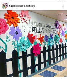 a wall with flowers painted on it that says to plant a garden is to believe in tomorrow