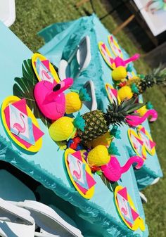 a table with pineapples and flamingos on it