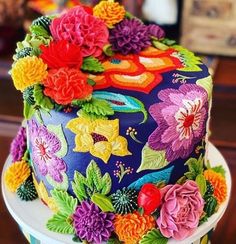 a multicolored cake with flowers on it