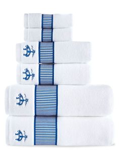 five white towels with blue anchors and stripes are stacked on top of each other in front of a white background