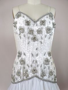 "This is a gorgeous little vintage couture dress! It's completely hand sewn, embellished with white sequins, glass beading and accented with iridescent rhinestone crystals. It's in excellent condition! Bust - 36\" Waist - 29\" Hips - 38\" Length - 33\" Tag Size - 8 All of my items come from a pet-free and smoke-free home. If you would like more info or have any questions, please don't hesitate to ask!" Sequined Corset Dress For Wedding And Prom Season, Couture Sleeveless Embellished Dress, Couture Embellished Sleeveless Dress, Wedding Corset Dress With Sequins For Prom Season, Fitted Sequin Dress With Rhinestones And Sweetheart Neckline, Beaded Sleeveless Dress With Fitted Bodice, Couture Embellished Dress With Fitted Bodice, Sleeveless Beaded Dress With Fitted Bodice, White Fitted Embellished Corset Dress