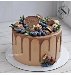 a cake with chocolate icing and blueberries on top