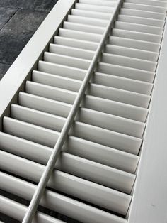 a close up view of the bottom part of a white cabinet with drawers on it