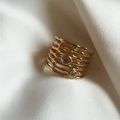 PRE-ORDER: Will ship in approximately 2 weeks. An intricately, high quality crafted adornment of 24-karat gold-plating, this bamboo-domed ring Design features an opulent sparkle provided by the small, brilliant-cut clear cubic zirconia stones. Adjustable / size 7 *2 week processing time Luxury Formal Ring With Fluted Bezel, Gold Midi Rings With Diamond Accents, Elegant Gold Dome Ring With Cubic Zirconia, Gold Midi Rings With Diamonds, Open Ring Design, Stackable Gold Crystal Ring With Diamonds, Gold Stackable Open Rings In Cubic Zirconia, Gold Stackable Midi Rings With Cubic Zirconia, Gold Dome Ring With Cubic Zirconia, Gold Diamond Stackable Crystal Ring