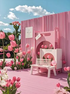 a pink and white bench sitting in front of a building with lots of tulips