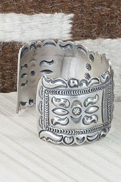 This sterling silver bracelet was made by Navajo silversmith Eugene Charley. The inside is signed and stamped sterling.Size: 5 3/4" (will fit up to a 7" wrist)Gap: 1 1/4"Width: 1 1/2"Free shipping on all orders! We ship with USPS and always include tracking. All orders ship within a day of payment.Returns are accepted up to 30 days after you receive your order. Just send us a message. Our shop offers cash back or store credit. The item must be returned in new condition. Western Sterling Silver Cuff Bracelet With Concho, Western Silver Cuff Bracelet With Concho, Western Silver Concho Cuff Bracelet, Bohemian Antique Silver Sterling Silver Bracelet, Bohemian Antique Sterling Silver Bracelet, Western Sterling Silver Cuff Bracelet Gift, Western Sterling Silver Cuff Bracelet, Artisan Silver Bracelet With Stamped Details, Western Style Sterling Silver Cuff Bracelet