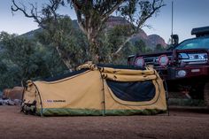 a tent is set up next to a truck