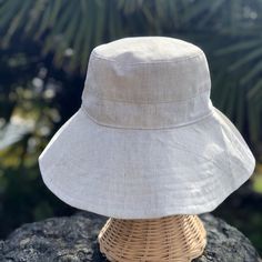 A beige linen sun hat for beach days and summer fun. This sun hat for women has a nice wide brim to protect your whole face and even your neck and chest. This hat folds easily to bring along in your bag. This hat is made from a medium weight homespun linen and cotton blend fabric in a neutral beige color. Inside liner is white cotton. I used a stiff interfacing for brim to keep it's shape. Brim measures 4.5" Crown depth is 3.5". Contact me for custom fit option. SIZES AVAILABLE S - measures 22.5 Hat For Beach, Custom Fitted Hats, Wide Brim Sun Hat, Cotton Blend Fabric, Sun Hats For Women, Hat For Women, Neutral Beige, Beach Hat, Beach Days