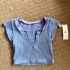 New With Tags And In Perfect Condition. Blue V-neck Top By Urban Outfitters, Blue Tops From Urban Outfitters For Spring, Urban Outfitters Blue Spring Tops, Urban Outfitters Blue Tops For Spring, Urban Outfitters Light Blue Casual Tops, Casual Light Blue Tops From Urban Outfitters, Trendy Light Blue Top From Urban Outfitters, Trendy Light Blue Tops From Urban Outfitters, Preppy Shirts