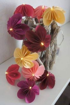 some paper flowers are sitting on a table