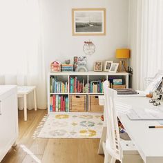 a room with a desk, bookshelf and various items on the shelves in it