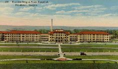 an old postcard shows the front of a large building