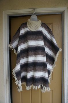 "Vintage cape - not sure of the material but its soft thick and warm. Condition - good but can use a cleaning. Measurements taken across front laid flat 43\" across 37\" length" Cozy Poncho For Cold Weather, Winter Poncho Cape For Cold Weather, Cozy Winter Cape Poncho, Winter Wool Poncho For Cold Weather, Wool Cape One Size For Winter, One-size Wool Winter Cape, One Size Wool Winter Cape, Cozy Wool Poncho Cape, Cozy Wool Long Sleeve Poncho