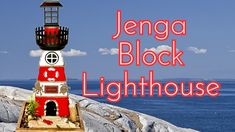 a red and white lighthouse sitting on top of a rock next to the ocean