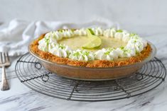 a pie on a wire rack with a fork