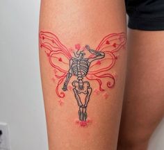 a woman's leg with a tattoo on it that has a skeleton in the shape of a butterfly