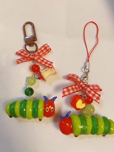 the very cute little caterpillars are hanging from the key chains