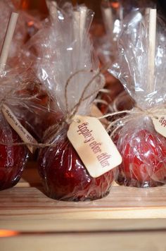 apples wrapped in cellophane and tied with twine on a wooden board for sale