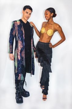 two people standing next to each other in front of a white background wearing clothes with fringes