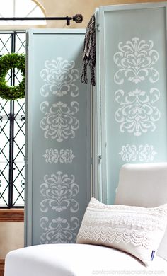 a white chair sitting in front of a blue door