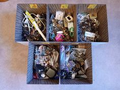 three boxes filled with assorted items sitting on top of a floor