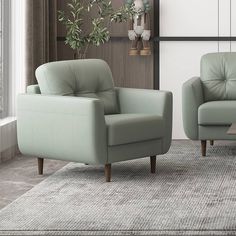 two light green leather chairs sitting in front of a window with potted plants on the wall