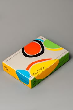 a book with an orange, yellow and blue cover sitting on top of a table