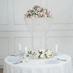 the table is set with flowers and silverware