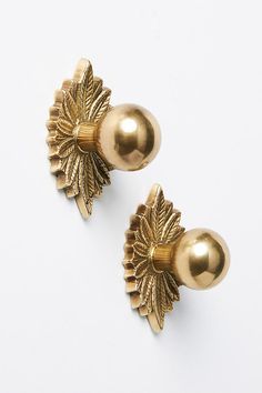 pair of gold - plated earrings with leaves on the back, front and side