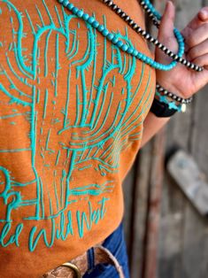 Turquoise Puff Ink Design by Texas True Threads Cactus design with Wild Wild West on the bottom Perfect western design True to size fit Available on a Brown tee or Burnt Orange Classy Cowgirl Outfits, Summer Western Outfits, Classy Cowgirl, Desert Scene, Wild Wild West, Western Tee, School Spirit Shirts, Western Boutique, Boyfriend Cut