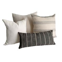 four pillows are stacked on top of each other, one is black and the other is white