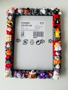 a photo frame made out of plastic toy figurines on a wall with a price label