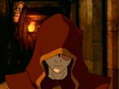 an animated image of a woman in a red hoodie looking at the camera while standing next to a fire place