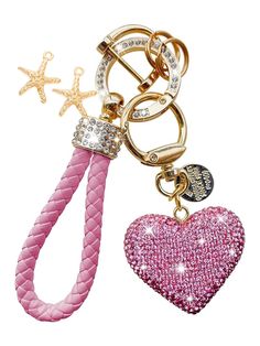 a key chain with a heart and star charms on it