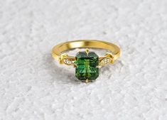 "Artdeco Green Tourmaline Ring with Diamonds, Vintage Rectangular Natural Green Tourmaline Ring, Unique Wedding Engagement Ring, Engage Jewelry Gift for her ╰►Specifications ➤ Made to Order.  ➤ Made in Turkey. ➤ 14K Gold ➤ Custom Gold Color: Rose Gold, Yellow Gold, White Gold ➤ Total CTW: 1.58 Carats ➤ Setting Type: Prong ➤ Natural Earth-Mined & Non-Conflict Diamonds & Gemstones ➤ Ready to Ship in 1 Week ╰► Center Stone Specifications ➤ Natural Tourmaline ➤ Shape: Emerald Cut ➤ Weight: 1.54 Cara Baguette Cut Tourmaline Jewelry For Weddings, Emerald-cut Tourmaline Wedding Jewelry, Wedding Rings With Baguette Cut Tourmaline, Emerald Cut Tourmaline Wedding Jewelry, Baguette Cut Tourmaline Wedding Ring, Elegant Tourmaline Wedding Ring, Elegant Wedding Tourmaline Rings, Elegant Green Ceremonial Rings, Yellow Gold Tourmaline Wedding Jewelry