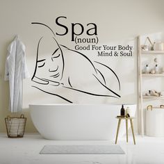 a white bath tub sitting next to a wall with the words spa written on it