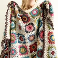 a crocheted granny's sweater with flowers on it