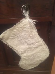 a white handkerchief hanging from a wooden cabinet