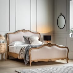 a bedroom with white walls and wooden furniture