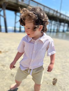 The ARTHUR Beige/White Multi Striped Woven Shirt is perfect for your little one this summer. Featuring a classic striped pattern, it is a versatile addition to any wardrobe. Upgrade your child's summer look this season! Striped Short Sleeve Tops For Playwear, Playful Summer Shirt For Playtime, Casual Summer Shirt For Playtime, Summer Short Sleeve Playwear Shirt, Summer Playwear Shirt With Short Sleeves, Playful Striped Tops For The Beach, Playful Striped Tops For Beach, Striped Tops For Summer Playtime, Toddler Essentials