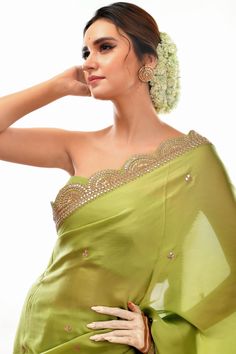 This elegant saree features a light green satin fabric and a stunningly hand-embroidered scalloped border. The gota patti design provides texture and dimension, making this saree a perfect choice for special occasions. Pista Green Sharara With Embroidered Border, Green Traditional Wear With Gota Work In Tissue Silk, Pista Green Chanderi Sharara With Embroidered Border, Designer Green Sharara With Embroidered Border, Designer Wear Green Sharara With Embroidered Border, Green Pre-draped Saree With Cutdana In Tissue Silk, Elegant Green Sharara With Gota Work, Green Sharara With Traditional Drape In Tissue Silk, Green Tissue Silk Sharara With Traditional Drape