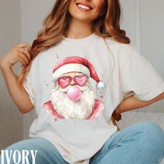 Add some pop of pink and playful boujee to your holiday season this Christmas with this retro Santa tshirt.  Brand is Comfort Colors 1717. Wash inside out with like colors, cool to warm water and hang to dry. Relaxed unisex fit, but size up 1 size for looser fit, and AT LEAST 2 sizes for oversized fit. *NO returns or exchanges for wrong sizing*. -Models wearing XL. -Done via Direct to Garment printing (NO vinyl or heat transfer). Print is directly printed onto the apparel and soaked INTO the fabric. Resulting in high quality, long lasting product. *PLEASE NOTE: avoid ironing, using high heat, and dry cleaning products*. 1. The photos provided are mockups only-unless stated otherwise. Some designs appear larger on the mockup. The color, print or placement of the design may differ slightly w Pink Letter Print T-shirt For Holiday, Pink Christmas Shirt, Pink Santa Shirt, Pink Christmas T-shirt With Letter Print, Trendy Pink T-shirt For Valentine's Day, Santa Tshirt, Preppy Coquette, Santa Tee, Pink Santa